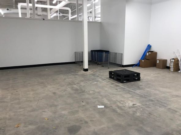 Picture of a store in Long Island that has just been cleaned out by a professional junk removal company. You can see that there is not much junk left in the store, only a few cardboard and plastic boxes.